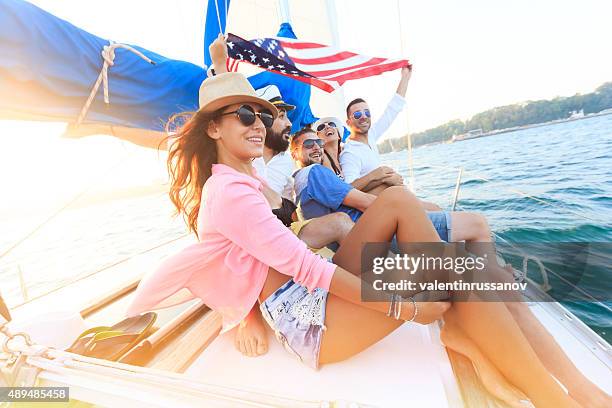 happy sailing crew on sailboat with american flag - american flag ocean 個照片及圖片檔