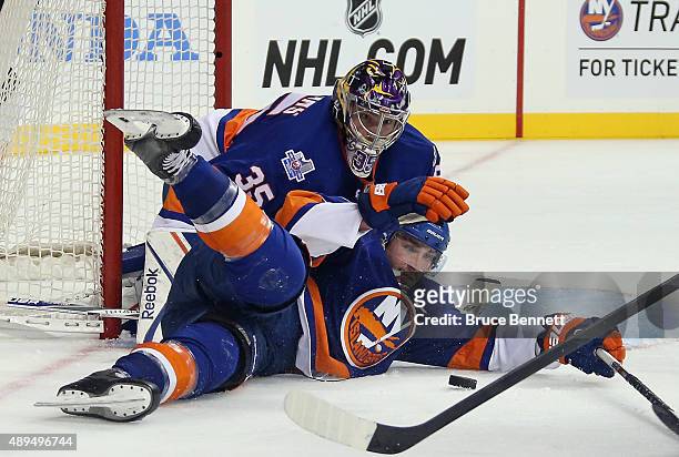 Stephon Williams and Johnny Boychuk of the New York Islanders defend against the Philadelphia Flyers during a preseason game at the Barclays Center...