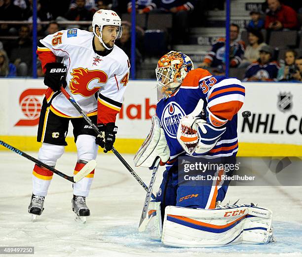 Morgan Klimchuk of the Calgary Flames watches the puck get past goalie Cam Talbot of the Edmonton Oilers at Rexall Place on September 21, 2015 in...