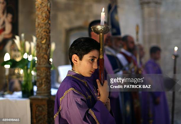 An Armenian altar server takes part in the first mass held in 51 years at the renovated Armenian church of the Virgin Mary in the Arabahmet...