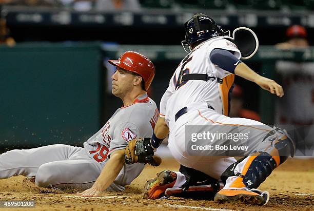 David Murphy of the Los Angeles Angels of Anaheim slides safely at home as Jason Castro of the Houston Astros is late with the tag in the ninth...