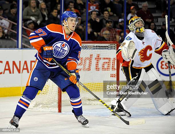 Connor McDavid of the Edmonton Oilers looks for a pass in front of goalie Mason McDonald of the Calgary Flames at Rexall Place on September 21, 2015...