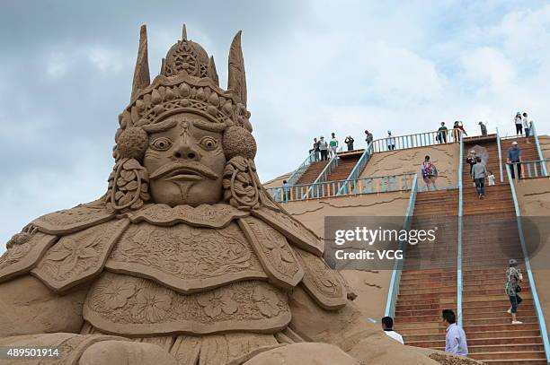 Visitors view sand sculptures at Zhujiajian Town in Putuo District on Septemebr 21, 2015 in Zhoushan, Zhejiang Province of China. All those sand...