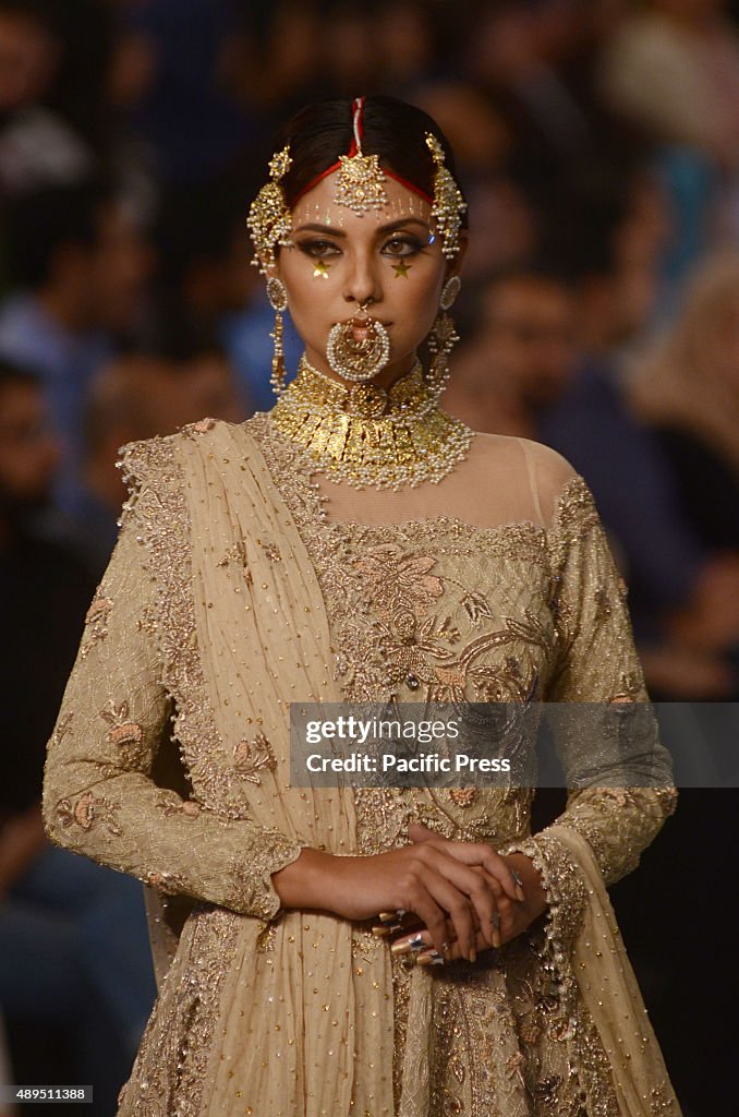 Pakistani models present creations by famous designers on...