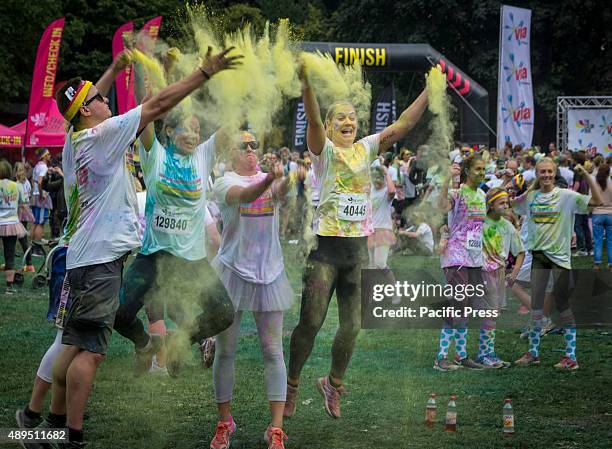 Participants throwing colored powder at each other during the Color Run. It is the world's largest series of "fun runs" and for the second year in a...