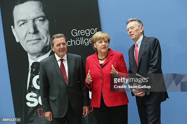 German Chancellor Angela Merkel, former Chancellor Gerhard Schroeder and biographer Gregor Schoellgen arrive for the presentation of Schroeder's...
