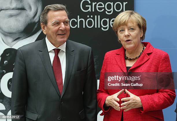 German Chancellor Angela Merkel and former Chancellor Gerhard Schroeder arrive for the presentation of Schroeder's biography on September 22, 2015 in...