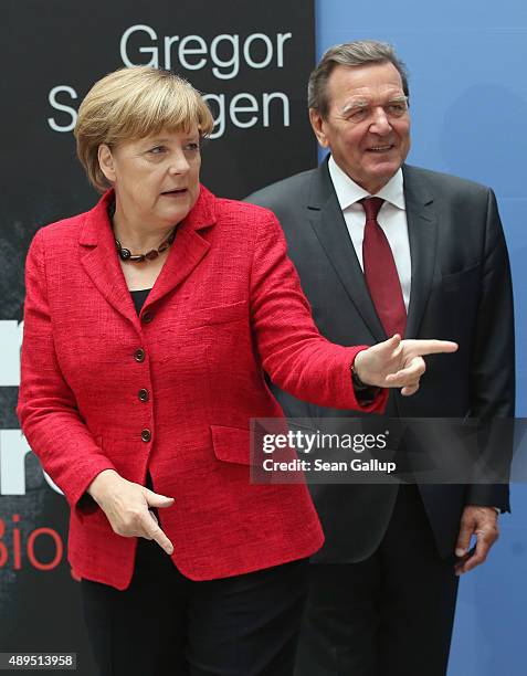 German Chancellor Angela Merkel and former Chancellor Gerhard Schroeder arrive for the presentation of Schroeder's biography on September 22, 2015 in...