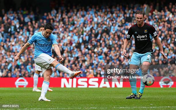 Samir Nasri of Manchester City scores the first goal during the Barclays Premier League match between Manchester City and West Ham United at the...