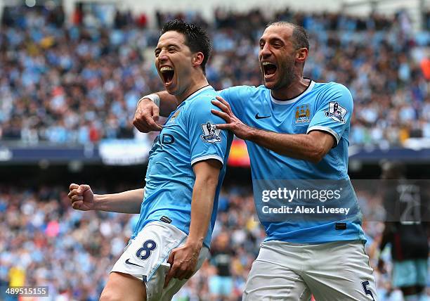 Samir Nasri of Manchester City celebrates scoring the first goal with team-mate Pablo Zabaleta during the Barclays Premier League match between...