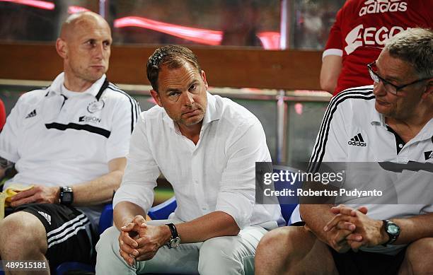 Ajax head coach, Frank De Boer sit on the bench during the international friendly match between Perija Jakarta and AFC Ajax on May 11, 2014 in...