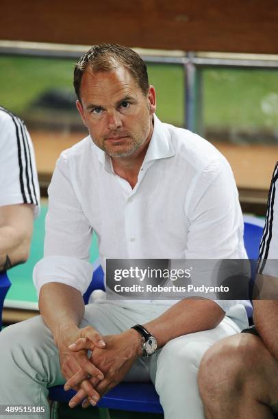 Ajax head coach, Frank De Boer sits on the bench during the international friendly match between Perija Jakarta and AFC Ajax on May 11, 2014 in...