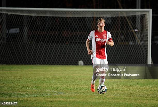 Christian Poulsen of AFC Ajax runs with the ball during the international friendly match between Perija Jakarta and AFC Ajax on May 11, 2014 in...