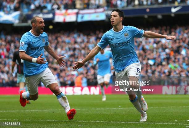 Samir Nasri of Manchester City celebrates scoring the first goal during the Barclays Premier League match between Manchester City and West Ham United...