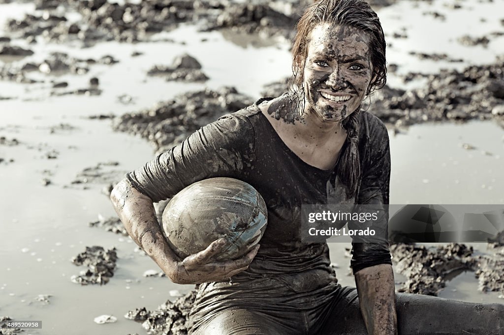 Young brunette female smiling during a mud run