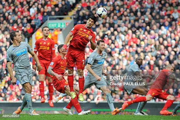 Liverpool's Uruguayan striker Luis Suarez heads the ball for team-mate Daniel Sturridge to score his team's second goal during the English Premier...