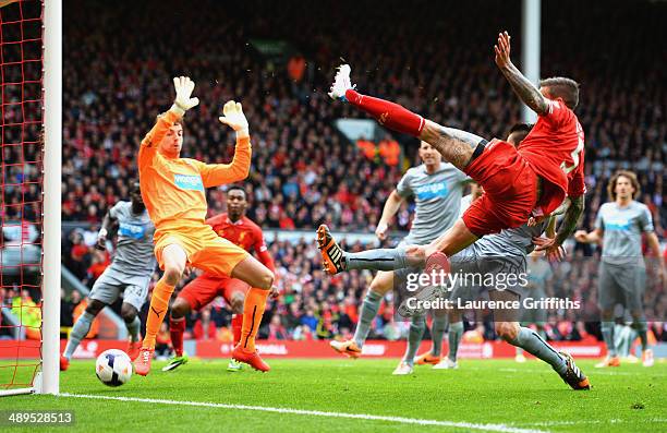 Daniel Agger of Liverpool shoots past Tim Krul of Newcastle United to score their first goal during the Barclays Premier League match between...