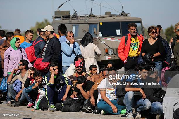 Migrants wait for buses to take them to Vienna after crossing the border from Hungary at Nickelsdorf on September 22, 2015 in Nickelsdorf, Austria....