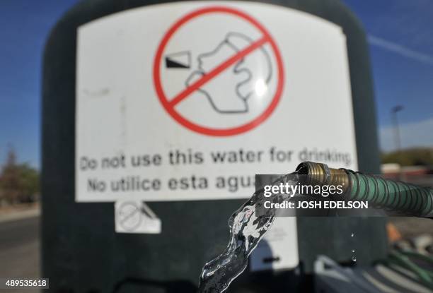 Hose spouts water from a non-potable tank in front of the Doyle Colony Fire Station in Porterville, California on September 21, 2015. California...