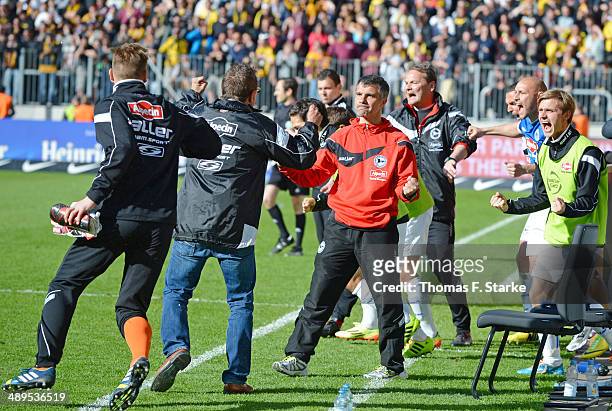 Head coach Norbert Meier and assistant coach Gino Lettieri of Bielefeld celebrate after winning the Second Bundesliga match between Dynamo Dresden...