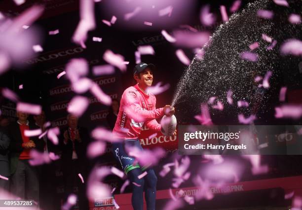 Michael Matthews of Australia and team Orica-GreenEDGE sprays champagne in celebration after retaining the Maglia Rosa leader's jersey following the...