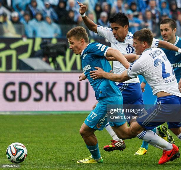 Oleg Shatov of FC Zenit St. Petersburg vies for the ball with Christian Noboa of FC Dynamo Moscow and Igor Denisov of FC Dynamo Moscow during the...