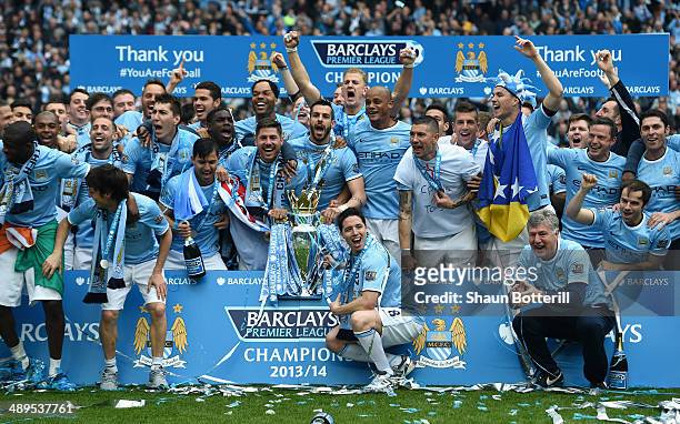 The Manchester City players celebrate with the Premier League trophy at the end of the Barclays Premier League match between Manchester City and West...