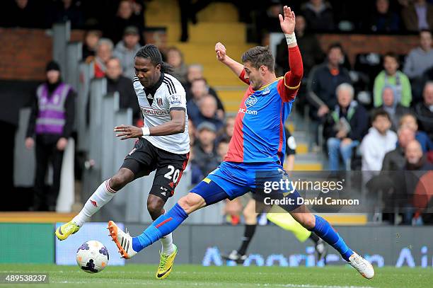 Joel Ward of Crystal Palace tackles Hugo Rodallega of Fulham during the Barclays Premier League match between Fulham and Crystal Palace at Craven...