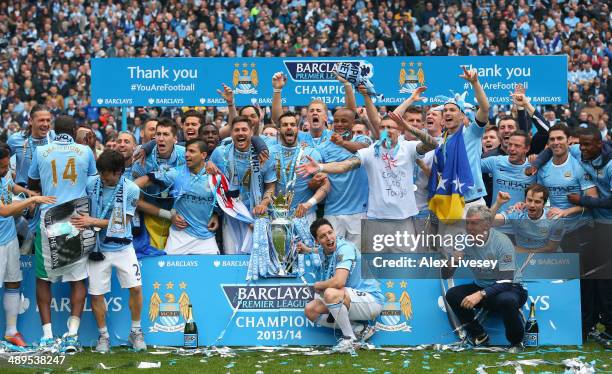 The Manchester City players celebrate with the Premier League trophy at the end of the Barclays Premier League match between Manchester City and West...