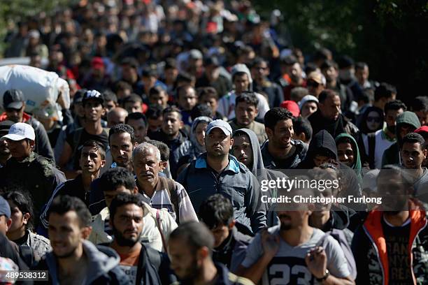 Hundreds of migrants who arrived on the second train today at Hegyeshalom on the Hungarian and Austrian border, walk the four kilometres into Austria...