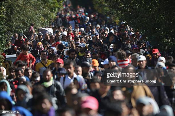 Hundreds of migrants who arrived on the second train today at Hegyeshalom on the Hungarian and Austrian border, walk the four kilometres into Austria...