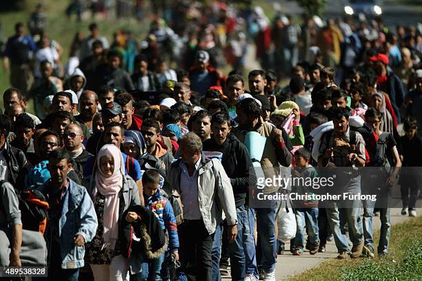 Hundreds of migrants who arrived on the second train today at Hegyeshalom on the Hungarian and Austrian border, walk the four kilometres into Austria...