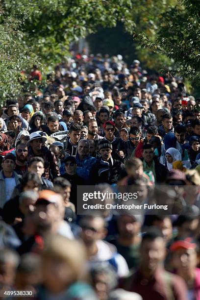 Hundreds of migrants who arrived on the second train today at Hegyeshalom on the Hungarian and Austrian border, walk the four kilometres into Austria...