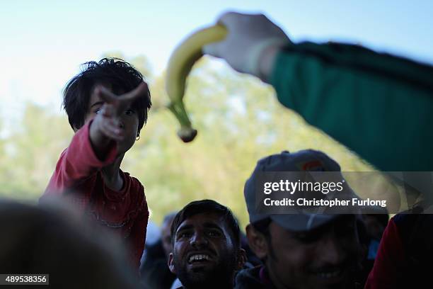 Migrants who arrived on the second train today at Hegyeshalom on the Hungarian and Austrian border, clamour for food as they walk the four kilometres...