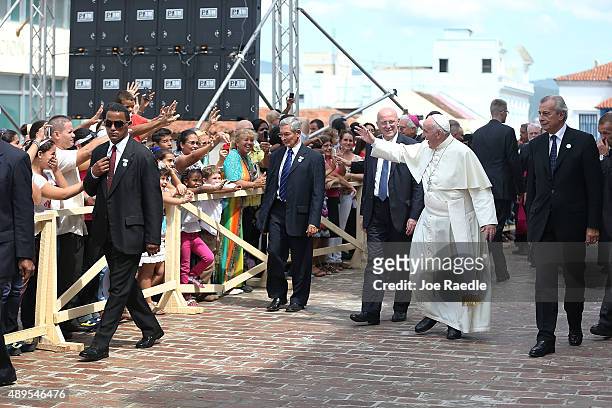 Pope Francis waves goodbye to people as he leaves the Cathedral of Our Lady of the Assumption after holding a mass and blessing the city on September...