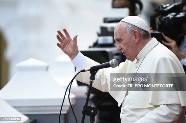 Pope Francis blesses the city from a balcony of the Cathedral of Our Lady of the Assumption in Santiago de Cuba, in eastern Cuba, on September 22,...