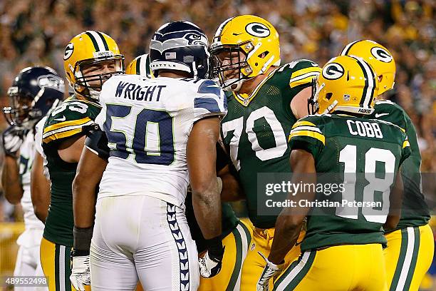 Guard T.J. Lang of the Green Bay Packers has words with outside linebacker K.J. Wright of the Seattle Seahawks during the NFL game at Lambeau Field...