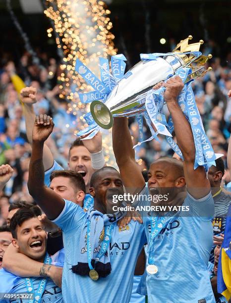 Manchester City's Belgian midfielder Vincent Kompany Manchester City's Ivorian defender Yaya Toure and Manchester City's Argentinian forward Sergio...