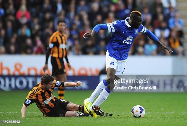 Lacina Traore of Everton is tackled by Alex Bruce of Hull City during the Barclays Premier League match between Hull City and Everton at KC Stadium...