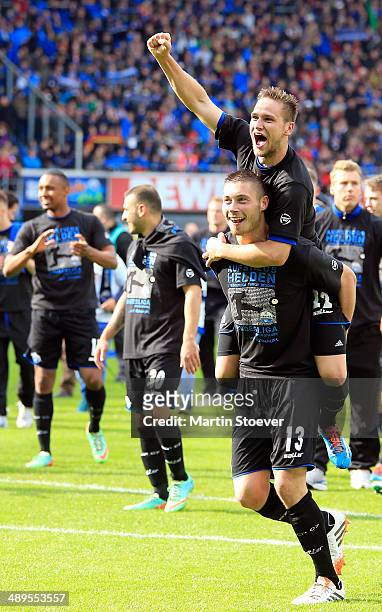 Christian Strohdiek and Michael Heinloth of Paderborn celebrate their promotion to the Bundesliga during the match between SC Paderborn and VFR Aalen...
