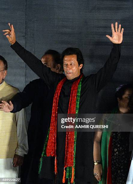 Cricketer-turned politician and chairman of Pakistan Tehreek-e-Insaf or Movement for Justice party, Imran Khan waves to supporters during an...