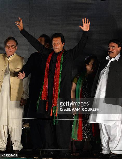 Cricketer-turned politician and chairman of Pakistan Tehreek-e-Insaf or Movement for Justice party, Imran Khan waves to supporters during an...