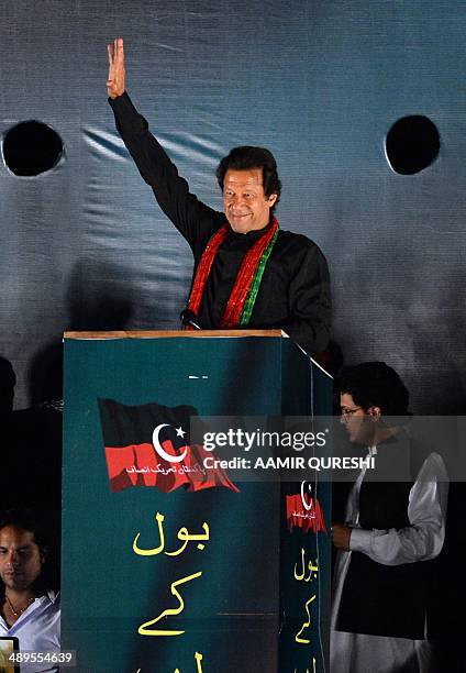 Cricketer-turned politician and chairman of Pakistan Tehreek-e-Insaf or Movement for Justice party, Imran Khan waves to supporters during an...