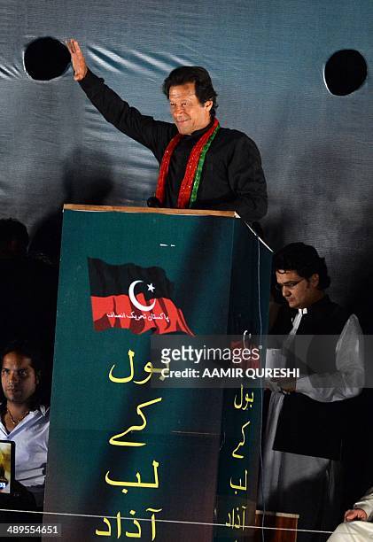 Cricketer-turned politician and chairman of Pakistan Tehreek-e-Insaf or Movement for Justice party, Imran Khan waves to supporters during an...