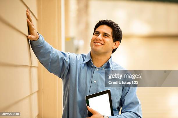 inspector, engineer examines building wall, window outdoors.  digital tablet. - quality control inspectors stock pictures, royalty-free photos & images