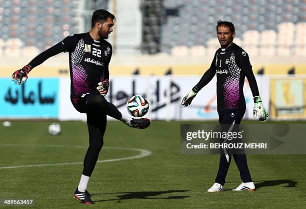 Iran's national team goalkeepers Alireza Haghighi and Rahman Ahmadi attend their last training session in Tehran on May 11 a day before departing to...
