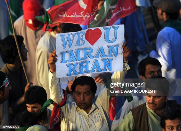 Supporters of cricketer-turned politician and chairman of Pakistan Tehreek-e-Insaf or Movement for Justice party, Imran Khan , attend an...