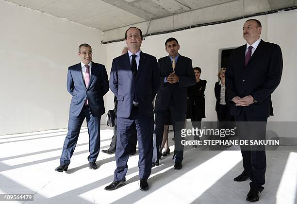 Azerbaijan President Ilham Aliyev and French President Francois Hollande visit the French school of Ville Blanche during its inauguration on May 11,...