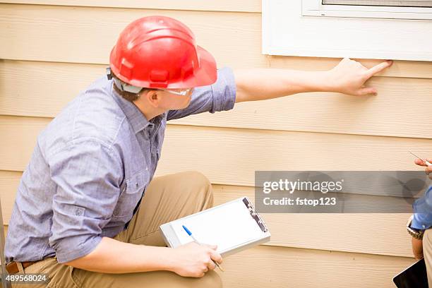 inspector or blue collar workers examines building wall, window. outdoors. - quality control stock pictures, royalty-free photos & images