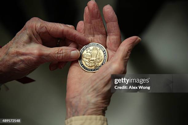 Participant of the first-ever all female Honor Flight receives a challenge coin from U.S. Veterans Affairs Secretary Bob McDonald during a visit at...